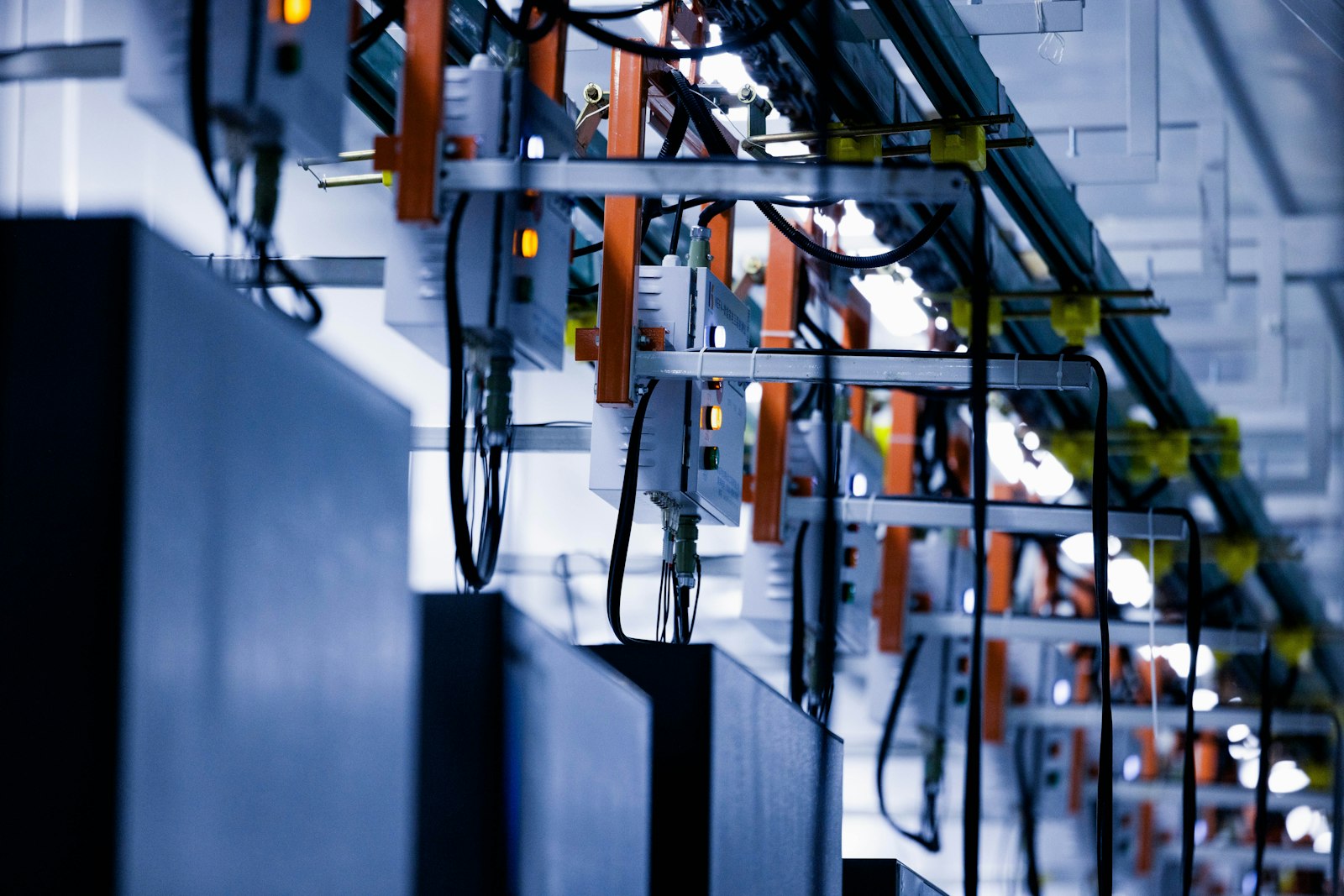Blue-lit data center with power and network cabling infrastructure